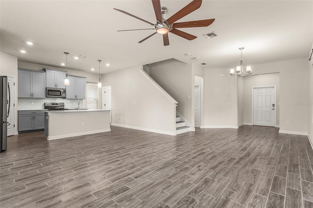 kitchen featuring appliances with stainless steel finishes, open floor plan, visible vents, and gray cabinetry