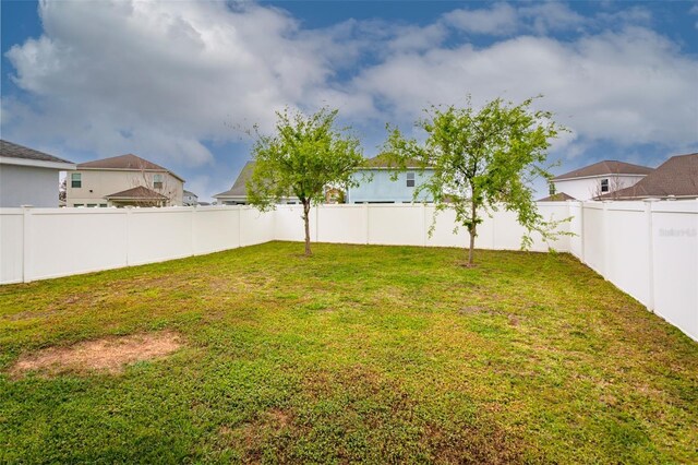 view of yard with a fenced backyard