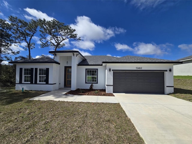 view of front of house featuring a garage, a shingled roof, driveway, stucco siding, and a front yard