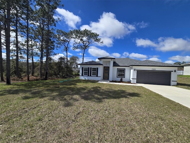 prairie-style home featuring driveway, a front lawn, an attached garage, and stucco siding