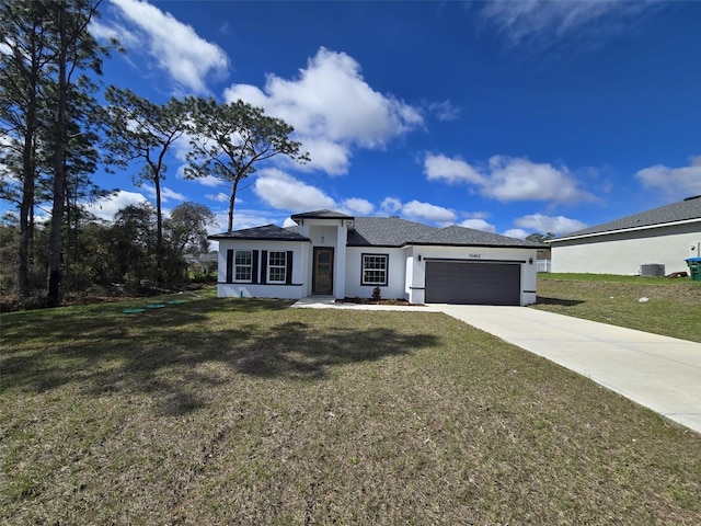 view of front of house featuring an attached garage, cooling unit, driveway, stucco siding, and a front yard