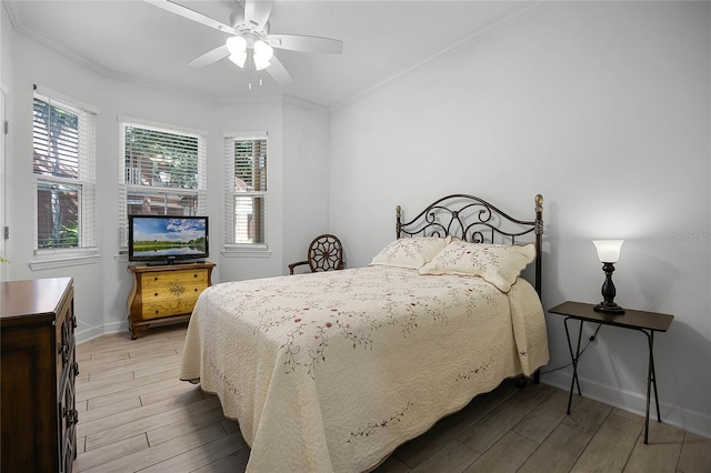 bedroom featuring crown molding, baseboards, a ceiling fan, and wood tiled floor