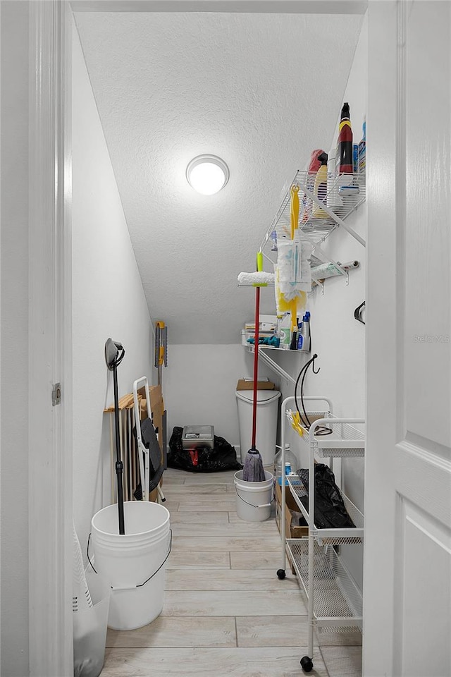 interior space featuring wood tiled floor and a textured ceiling