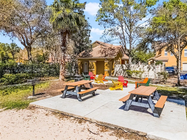 view of patio / terrace with an outdoor fire pit and fence