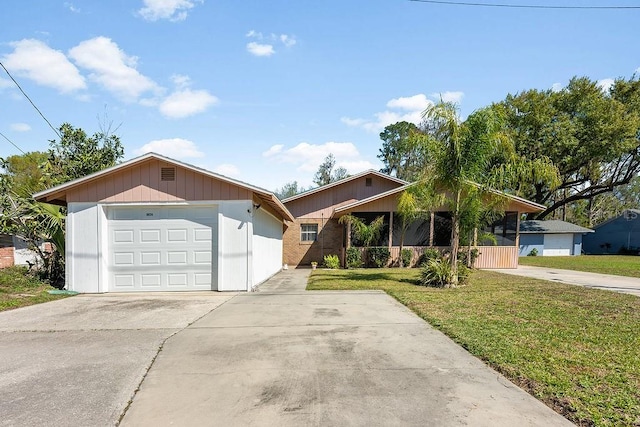 view of front of house featuring brick siding, an attached garage, concrete driveway, and a front yard