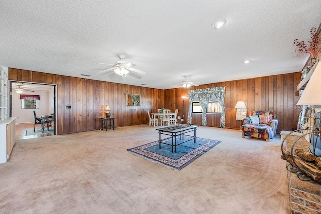 interior space featuring a wealth of natural light, carpet floors, and a textured ceiling