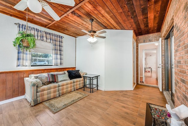 living room featuring brick wall, wood ceiling, and ceiling fan