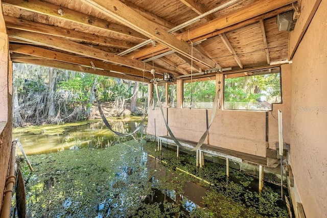 sunroom / solarium with a water view