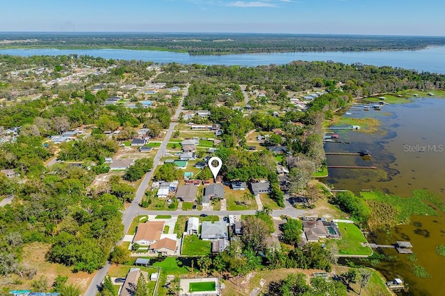 bird's eye view with a residential view, a wooded view, and a water view