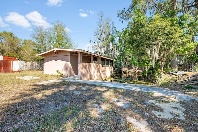 exterior space with an outdoor structure and fence
