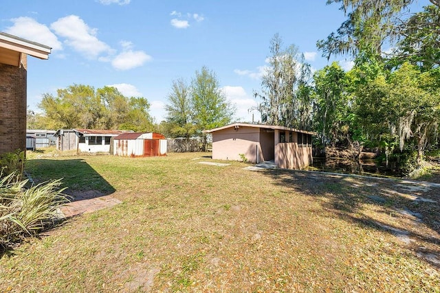 view of yard with an outbuilding and a shed