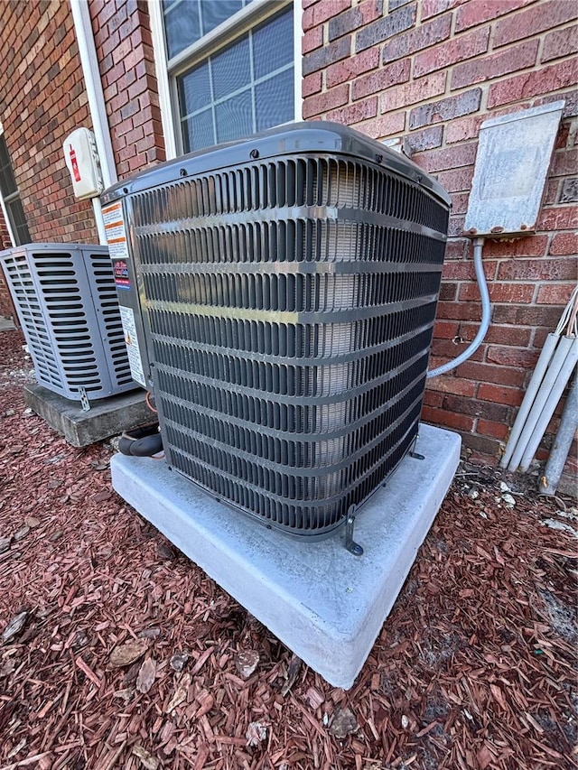 exterior details with cooling unit and brick siding