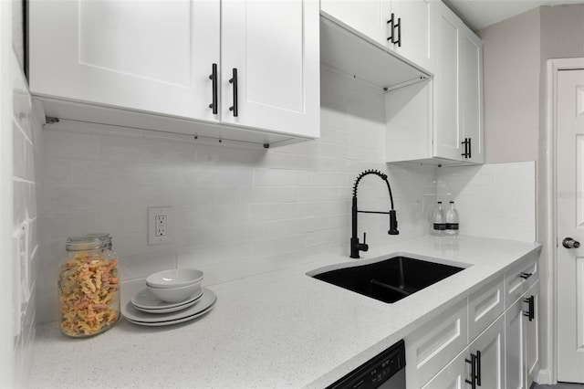 1920 E Edgewood Dr Unit A5, Lakeland, FL 33803 - kitchen featuring white cabinetry, backsplash, and light stone countertops