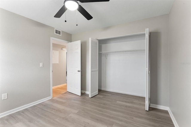 1920 E Edgewood Dr Unit A5, Lakeland, FL 33803 - unfurnished bedroom featuring light wood finished floors, ceiling fan, and a closet