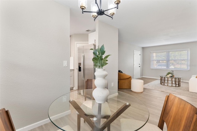 1920 E Edgewood Dr Unit A5, Lakeland, FL 33803 - dining space with light wood finished floors and a chandelier