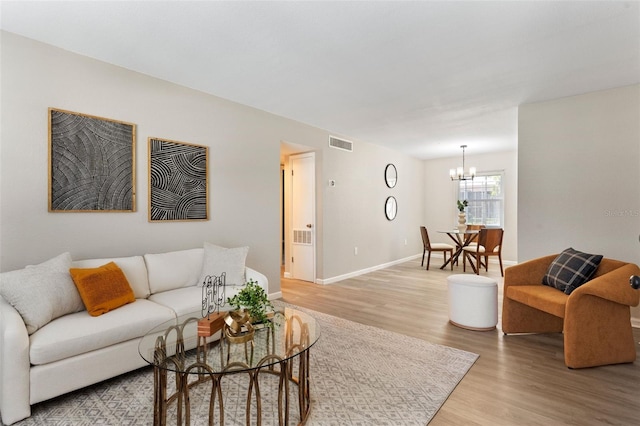 1920 E Edgewood Dr Unit A5, Lakeland, FL 33803 - living area with light wood-style flooring and a chandelier