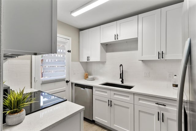 1920 E Edgewood Dr Unit A5, Lakeland, FL 33803 - kitchen with dishwasher, fridge, backsplash, and white cabinets
