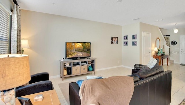 living room with baseboards and light tile patterned floors