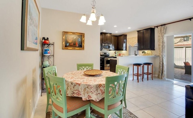 dining space featuring light tile patterned floors, a notable chandelier, and recessed lighting