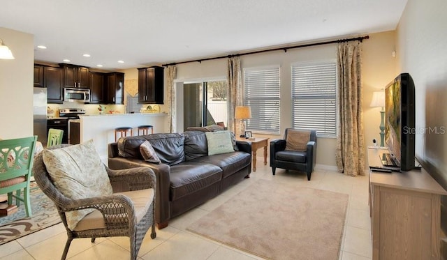 living area featuring light tile patterned floors and recessed lighting