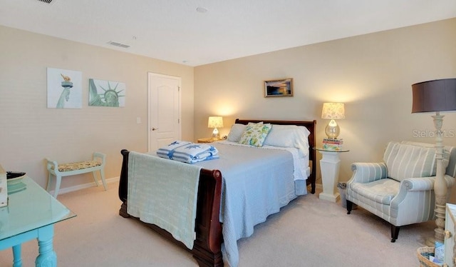 bedroom featuring visible vents, light colored carpet, and baseboards