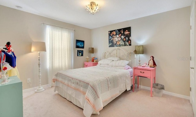 bedroom with baseboards and carpet