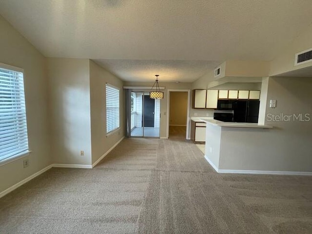 kitchen with light countertops, visible vents, light carpet, and baseboards