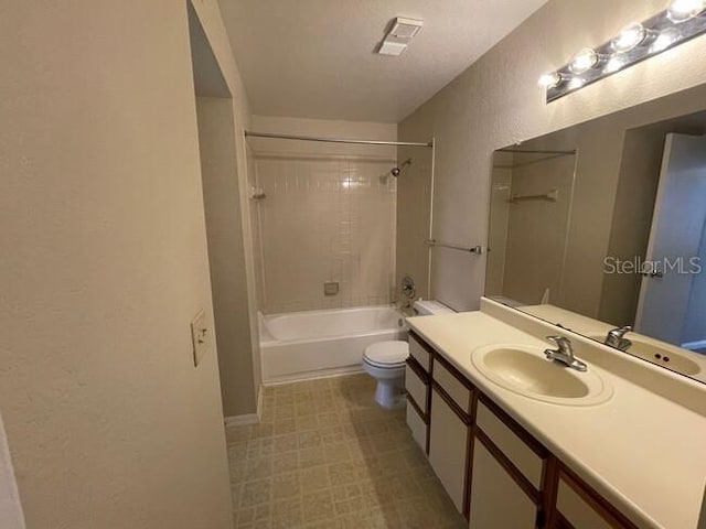 bathroom with visible vents, shower / bath combination, a textured wall, toilet, and vanity