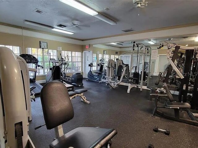 gym featuring a ceiling fan and visible vents