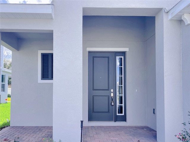 entrance to property with stucco siding