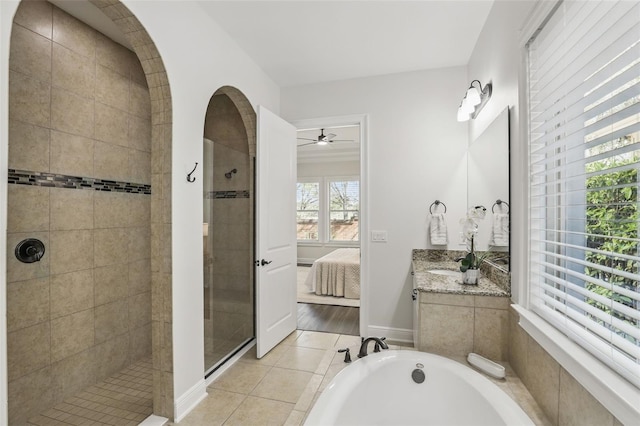 ensuite bathroom with connected bathroom, vanity, a tile shower, tile patterned floors, and a bathtub