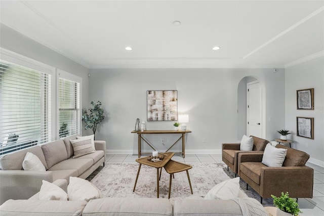 living room with ornamental molding, arched walkways, and light tile patterned floors