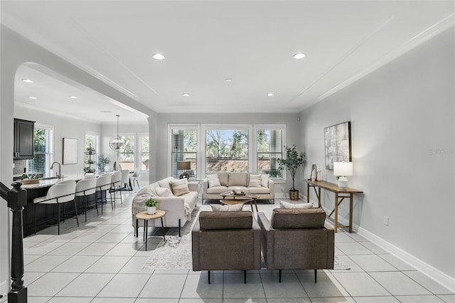 living room featuring ornamental molding, light tile patterned flooring, and a wealth of natural light