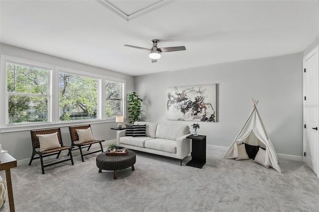 living room featuring carpet floors, ceiling fan, and baseboards