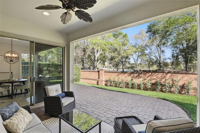 view of patio with fence and a ceiling fan