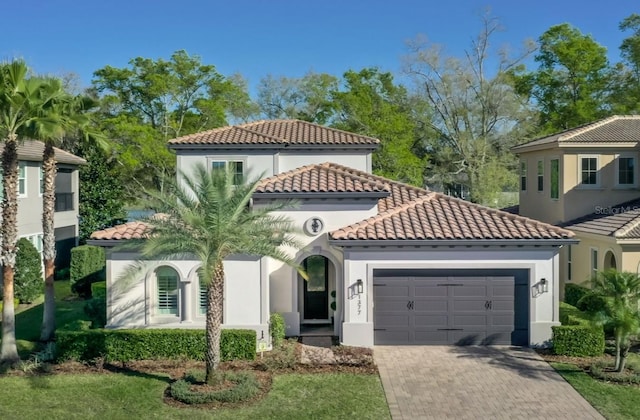 1377 Tappie Toorie Cir, Lake Mary, FL 32746 - mediterranean / spanish home with a tile roof, a garage, decorative driveway, and stucco siding