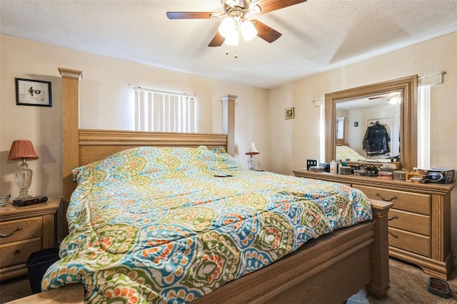 carpeted bedroom with a textured ceiling and ceiling fan