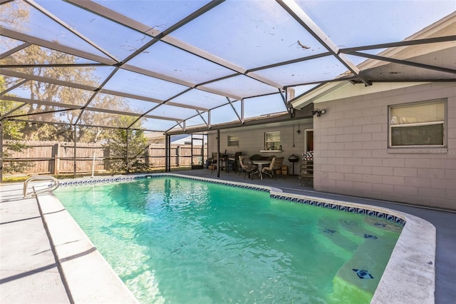 view of pool with a patio area, a fenced in pool, a lanai, and fence