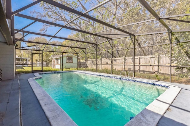 view of pool with glass enclosure, a patio area, and a fenced in pool