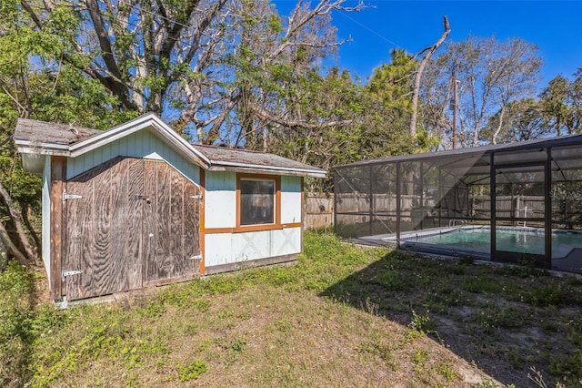 view of outbuilding with a fenced in pool, an outdoor structure, and a fenced backyard