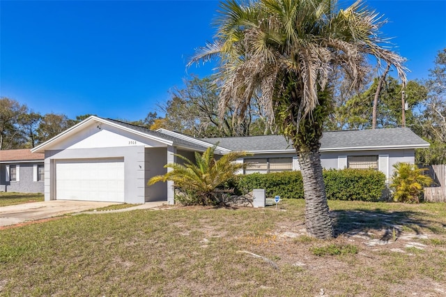 ranch-style home featuring stucco siding, driveway, a front lawn, and an attached garage