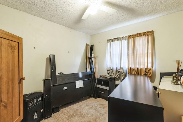 office area featuring light colored carpet, a textured ceiling, and ceiling fan