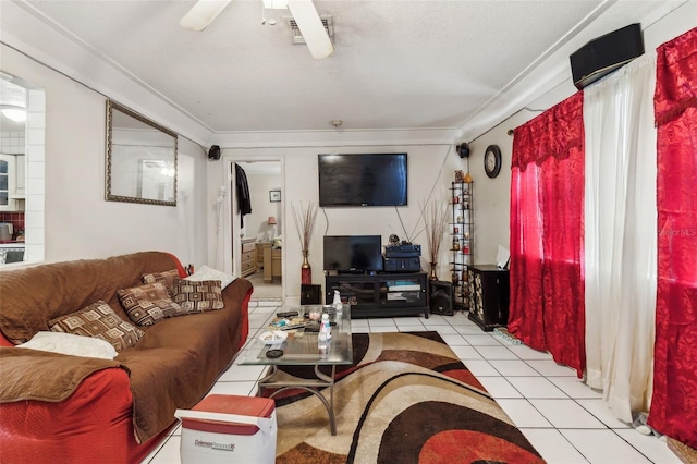 living area featuring light tile patterned flooring, visible vents, and ceiling fan