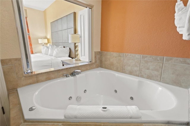 full bath with a textured wall and a jetted tub