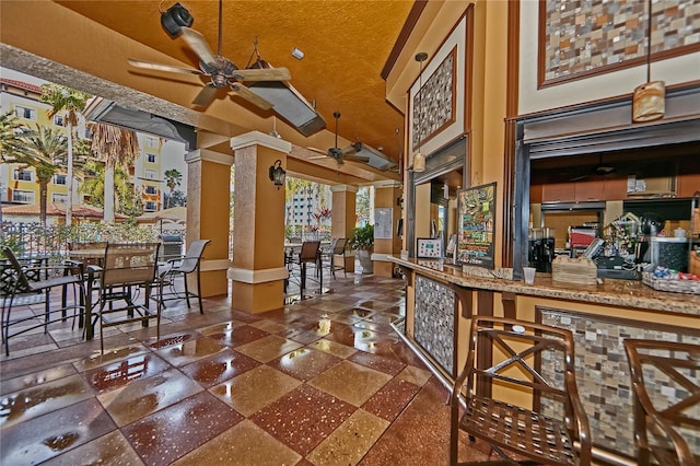 interior space featuring high vaulted ceiling and a ceiling fan