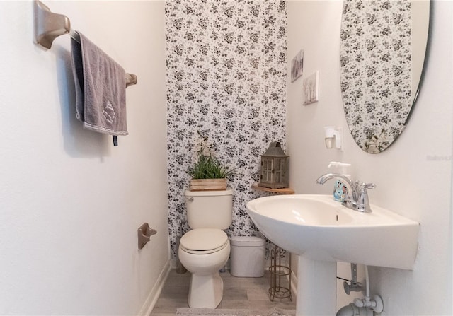 7407 Ripplepointe Way, Windermere, FL 34786 - bathroom with toilet, baseboards, and wood finished floors