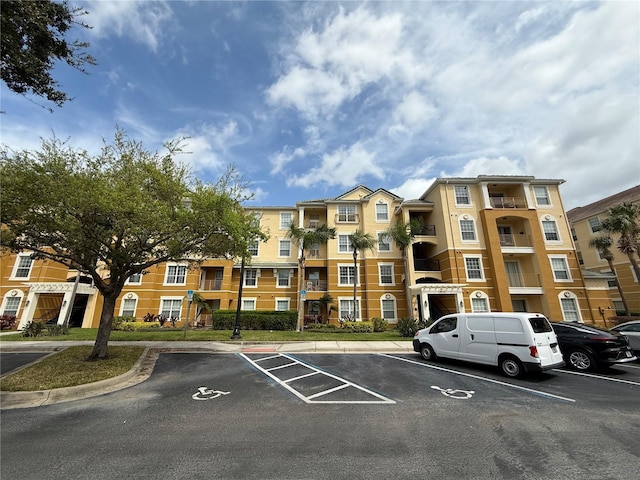 view of building exterior featuring uncovered parking