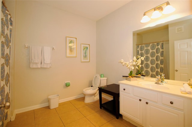 bathroom featuring toilet, baseboards, vanity, and tile patterned floors