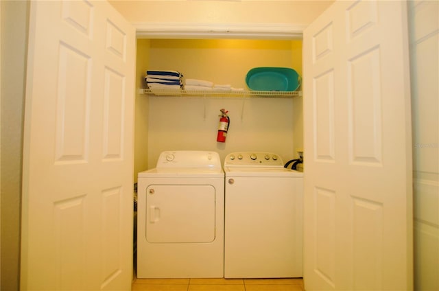 laundry area with laundry area, light tile patterned flooring, and independent washer and dryer