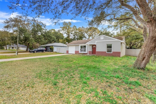 single story home featuring brick siding, fence, a garage, driveway, and a front lawn